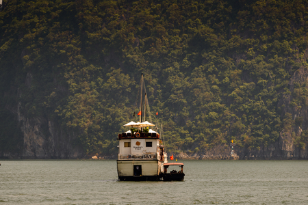 HA LONG CITY, VIETNAM - SEP 23, 2014: Touristoc Boats near the port of the Halong city where many touristic boats start jorneys over the Halong bay which is UNESCO World heritageのeditorial素材
