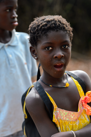 SOGA, GUINEA BISSAU - MAY 5, 2017: Unidentified local little girl in earing opens her mouth in a village of the Soga island. People in G.-Bissau still suffer of povertyのeditorial素材