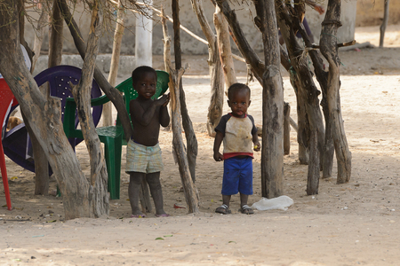 ORANGO ISLAND, GUINEA BISSAU - MAY 3, 2017: Unidentified local children play in the yard in the Etigoca village. People in G.-Bissau suffer of poverty due to the bad economyのeditorial素材