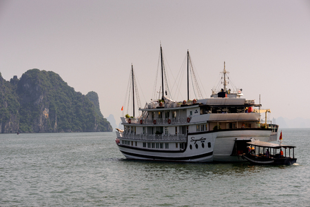 HA LONG CITY, VIETNAM - SEP 23, 2014: Touristoc Boats near the port of the Halong city where many touristic boats start jorneys over the Halong bay which is UNESCO World heritageのeditorial素材
