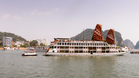 HA LONG CITY, VIETNAM - SEP 23, 2014: Touristoc Boats near the port of the Halong city where many touristic boats start jorneys over the Halong bay which is UNESCO World heritageのeditorial素材