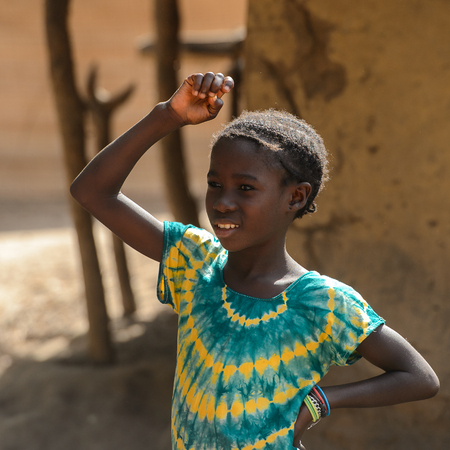 CANHABAQUE, GUINEA BISSAU - MAY 4, 2017: Unidentified local little girl stands in a village of the Canhabaque island. People in G.-Bissau still suffer of povertyのeditorial素材