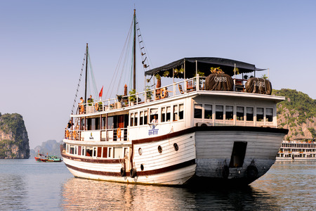 HA LONG BAY, VIETNAM - SEP 23, 2014: Small touristic ship in the Halong bay, Vietnam. UNESCO World Heritageのeditorial素材