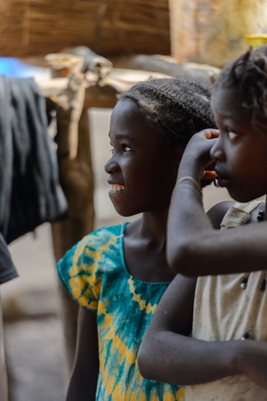 CANHABAQUE, GUINEA BISSAU - MAY 4, 2017: Unidentified local girls stand in a village of the Canhabaque island. People in G.-Bissau still suffer of povertyのeditorial素材