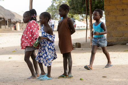 ORANGO ISLAND, GUINEA BISSAU - MAY 3, 2017: Unidentified local children stand in the middle of the...