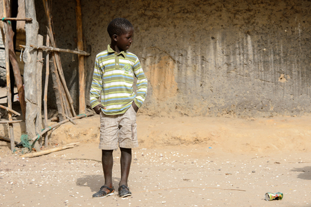 ORANGO ISLAND, GUINEA BISSAU - MAY 3, 2017: Unidentified local little boy looks away in the Etigoca village. People in G.-Bissau suffer of poverty due to the bad economyのeditorial素材