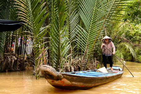 SONG NUOC MIEN TAY, VIETNAM - OCT 5, 2014: Unidentified Vietnamese woman sails a boat over the Mekong river. Mekong is the 12th longest river in the worldのeditorial素材