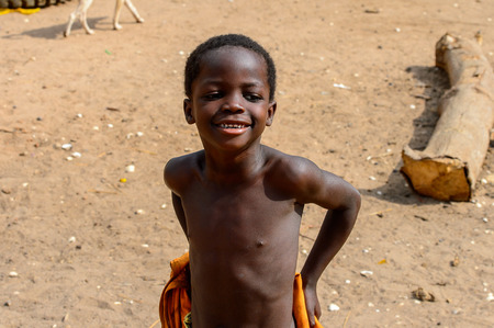 SOGA, GUINEA BISSAU - MAY 5, 2017: Unidentified local little boy stands in a village of the Soga island. People in G.-Bissau still suffer of povertyのeditorial素材