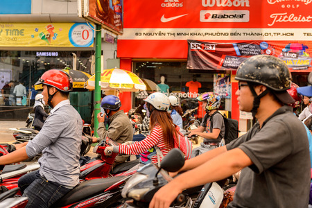 HO CHI MINH, VIETNAM - OCT 5, 2014: Unidentified Vietnamese people on the typical transportation way...
