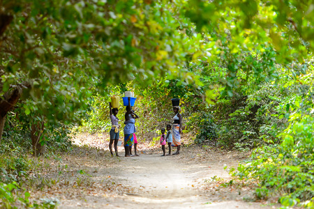 SOGA, GUINEA BISSAU - MAY 5, 2017: Unidentified local people walk along the street in a village of the Soga island. People in G.-Bissau still suffer of povertyのeditorial素材