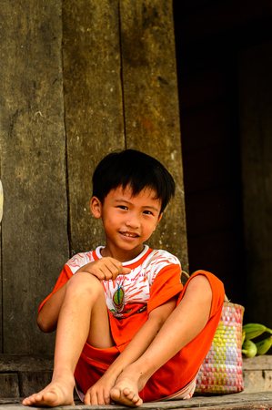 AP VAN HOA QUOI HOA TAY, VIETMAN - OCT 5, 2014: Unidentified Vietnamese boy near the house in Vietnam. 86% of Vietnamese people belong to the Viet ethnic groupのeditorial素材