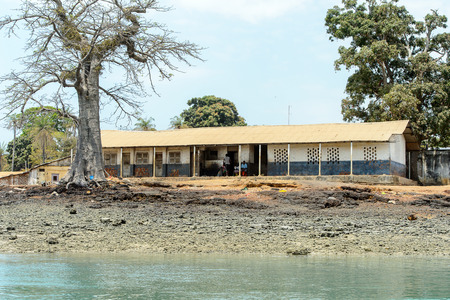 BUBAQUE, GUINEA BISSAU - MAY 5, 2017: Unidentified local people sit in a village of the Bubaque island. People in G.-Bissau still suffer of povertyのeditorial素材
