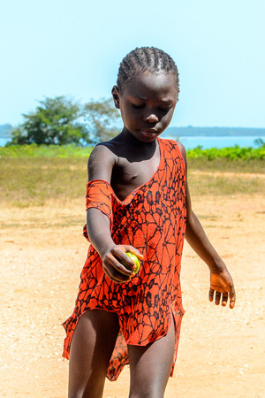 BUBAQUE, GUINEA BISSAU - MAY 5, 2017: Unidentified local little boy stands on the street in a village of the Bubaque island. People in G.-Bissau still suffer of povertyのeditorial素材