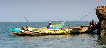 BOLAMA ISLAND, GUINEA BISSAU - MAY 6, 2017: Unidentified local man sits in the boat in the ghost town of Bolama, the former capital of Portuguese Guineaのeditorial素材