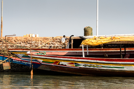 BOLAMA ISLAND, GUINEA BISSAU - MAY 6, 2017: Unidentified local boy stands on the boat from behind in the ghost town of Bolama, the former capital of Portuguese Guineaのeditorial素材
