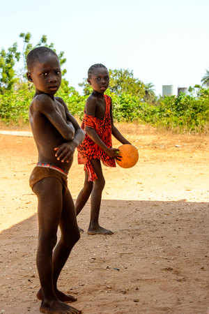BUBAQUE, GUINEA BISSAU - MAY 5, 2017: Unidentified local little boy stands on the street in a village of the Bubaque island. People in G.-Bissau still suffer of povertyのeditorial素材