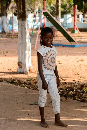 BOLAMA ISLAND, GUINEA BISSAU - MAY 6, 2017: Unidentified local little girl with braids smiles in the ghost town of Bolama, the former capital of Portuguese Guineaのeditorial素材