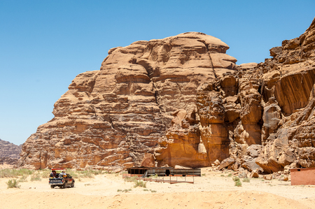 WADI RUM, JORDAN - APR 30, 2014: Mitsubishi jeep with the tourists in the desert of Wadi Rum. Wadi Rum valley is the UNESCO World Heritage siteのeditorial素材