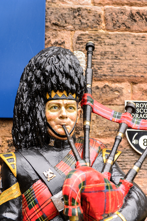 EDINBURGH, SCOTLAND - JULY 17, 2016: Figure playing a bagpipes at the  Edinburgh Castle. The Castle was involved in many historical conflicts since 14th centuryのeditorial素材