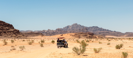 WADI RUM, JORDAN - APR 30, 2014: Mitsubishi jeep with the tourists in the desert of Wadi Rum. Wadi Rum valley is the UNESCO World Heritage siteのeditorial素材