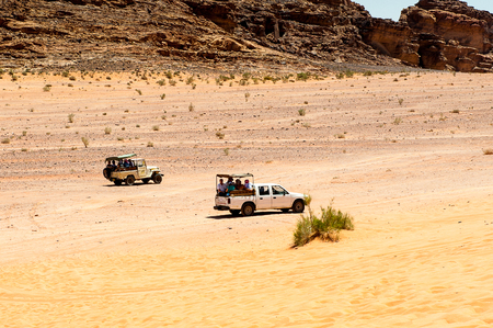 WADI RUM, JORDAN - APR 30, 2014: Touristic jeeps in the desert of Wadi Rum. Wadi Rum valley is the UNESCO World Heritage siteのeditorial素材
