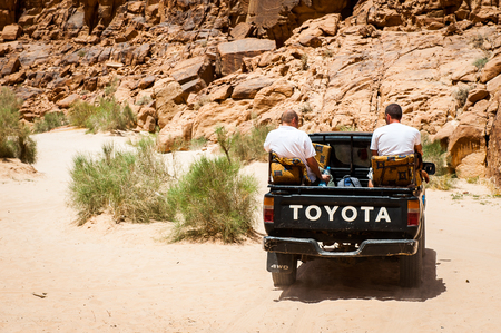 WADI RUM, JORDAN - APR 30, 2014: Mitsubishi jeep with the unidentified tourists in the desert of Wadi Rum. Wadi Rum valley is the UNESCO World Heritage siteのeditorial素材