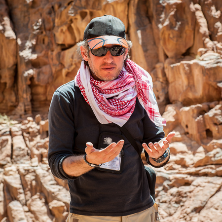 WADI RUM, JORDAN - APR 30, 2014: Unidentified touristic guide talks about the history of the Wadi Rum valley. Wadi Rum valley is the UNESCO World Heritage siteのeditorial素材