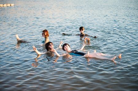 DEAD SEA RESORT, JORDAN - APR 30, 2014: Unidentified Chinese girls swim in the Dead Sea in Jordan. Dead Sea water is used for medical purposes for the people with skin problemsのeditorial素材