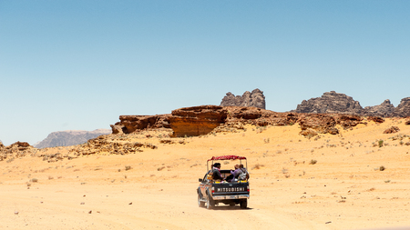 WADI RUM, JORDAN - APR 30, 2014: Mitsubishi jeep with the tourists in the desert of Wadi Rum. Wadi Rum valley is the UNESCO World Heritage siteのeditorial素材