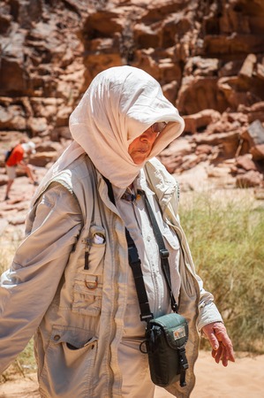 WADI RUM, JORDAN - APR 30, 2014: Unidentified tourist walks in the Wadi Rum valley. Wadi Rum valley is the UNESCO World Heritage siteのeditorial素材