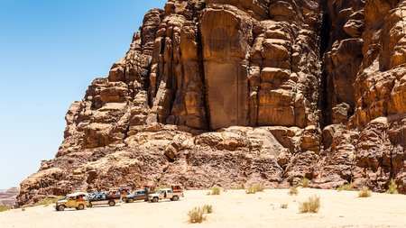 WADI RUM, JORDAN - APR 30, 2014: Touristic jeeps for the tourists in the desert of Wadi Rum. Wadi Rum valley is the UNESCO World Heritage siteのeditorial素材