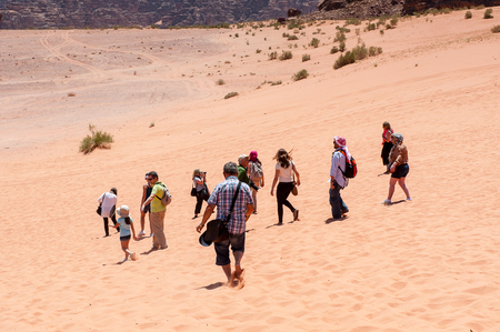 WADI RUM, JORDAN - APR 30, 2014: Unidentified tourists walk over the Wadi Rum valley. Wadi Rum valley is the UNESCO World Heritage siteのeditorial素材