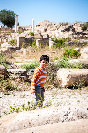 GADARA, JORDAN - MAY 2, 2014: Unidentified boy walks in the ancient town of Gadara, Jordan. By the third century BC the Gadara town was of some cultural importance.のeditorial素材
