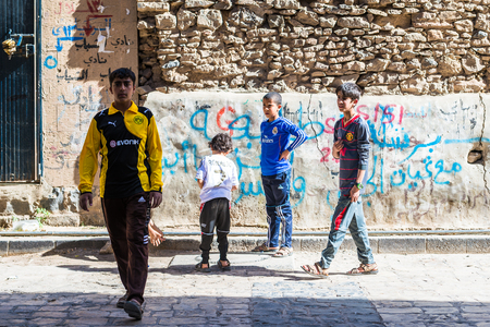 SANA'A, YEMEN - JAN 11, 2014: Unidentified Yemeni children play in the street in Sana'a. Children of Yemen grow up without educationのeditorial素材
