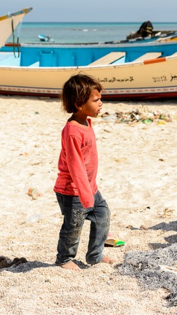 SOCOTRA, YEMEN - JAN 12, 2014: Unidentified Yemeni little boy walks on the beach of the Island of Socotra. Children in Socotra live in poverty and grow without educationのeditorial素材