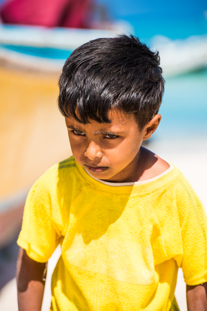 SOCOTRA, YEMEN - JAN 12, 2014: Unidentified Yemeni little boy plays on the beach of the Island of Socotra. Children in Socotra live in poverty and grow without educationのeditorial素材