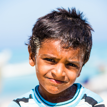 SOCOTRA, YEMEN - JAN 12, 2014: Unidentified Yemeni little boy on the beach of the Island of Socotra. Children in Socotra live in poverty and grow without educationのeditorial素材