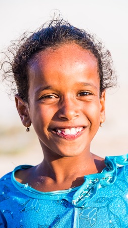 SOCOTRA, YEMEN - JAN 12, 2014: Unidentified Yemeni little girl portrait on  the beach of the Island of Socotra. Children in Socotra live in poverty and grow without educationのeditorial素材