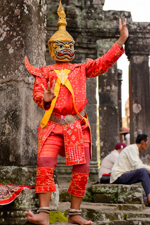 ANGKOR, CAMBODIA - SEP 27, 2014: Unidentified people wearing bright tradtional clothes at Bayon, Khmer temple at Angkor in Cambodia.のeditorial素材