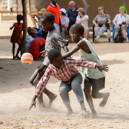 ORANGO ISLAND, GUINEA BISSAU - MAY 3, 2017: Unidentified local boys play football on the Orange islandのeditorial素材