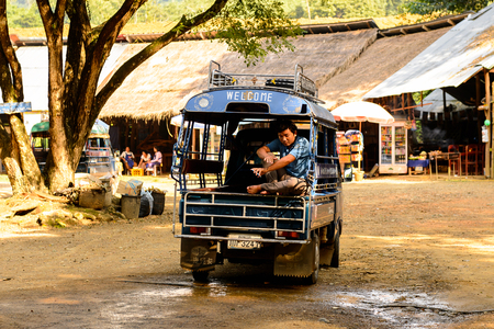 LUANG PRABANG, LAOS - SEP, 25, 2014: Taxi cab tuk-tuk in Luang Prabang, local way of transportationのeditorial素材