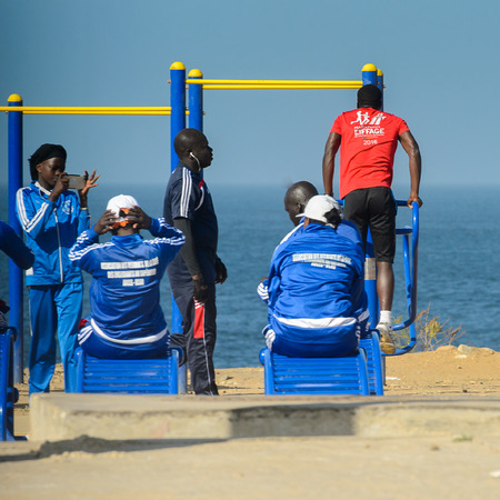 DAKAR, SENEGAL - APR 23, 2017: Unidentified Senegalese people do physical exercises on the beach in...