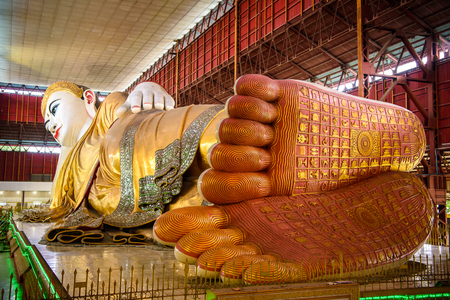 YANGON, MYANMAR - AUG 24, 2016: Giant statue of reclining Buddha at the Chaukhtatgyi Temple, the most well-known Buddhist temple in Bahan Township, Yangon, Myanmar.のeditorial素材