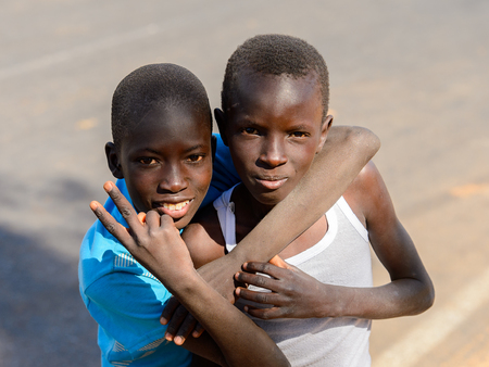 LAMPOUL DESERT village, SENEGAL - APR 23, 2017: Unidentified Senegalese two boys hug each other in a village near the Lampoul Desertのeditorial素材