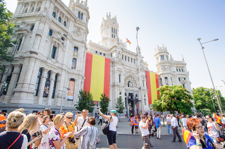 MADRID, SPAIN - JUN 19, 2014: Unidentified Spanish people with national flags in the centre of Madrid on a case the celebration on a day of the inauguration of the New King of Spain Felipe IVのeditorial素材