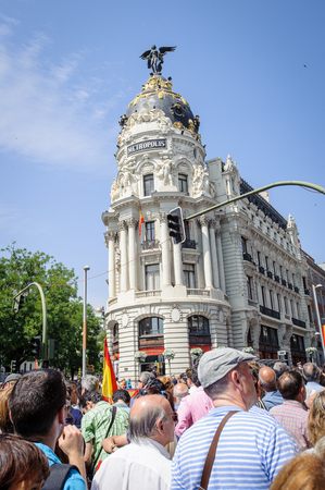 MADRID, SPAIN - JUN 19, 2014: Unidentified Spanish people with multiple national flags walk in the centre of Madrid on a case of the celebration on a day of the inauguration of the New King of Spain Felipe IVのeditorial素材