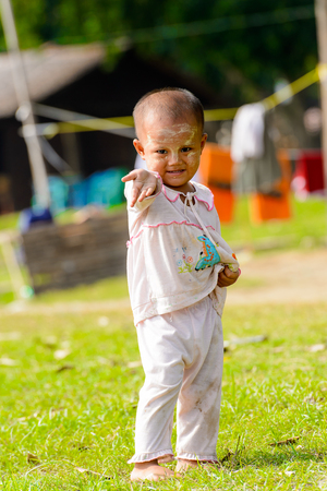 MINGUN, MYANMAR - AUG 26, 2016: Unidentified Burmese little girl with painted cheeks. 68 per cent of  Myanma people belong to Bamar ethnic groupのeditorial素材