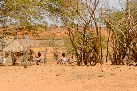 ROAD TO LAMPOUL, SENEGAL - APR 23, 2017: Unidentified Senegalese two little boys play in the yard. Still many people in Senegal live in povertyのeditorial素材