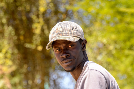 DJOUDJ, SENEGAL - APR 25, 2017: Unidentified Senegalese man in a cap looks away in Djoudj, popular touristic destinationのeditorial素材