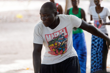 Kaguit vil., SENEGAL - APR 30, 2017: Unidentified Diola man in white shirt moves during a traditional dance Kumpo in a Sacred Forest near Kaguit villageのeditorial素材